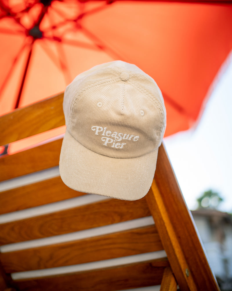 Hemlock Pleasure Pier Baseball Hat in oat color by pool chair