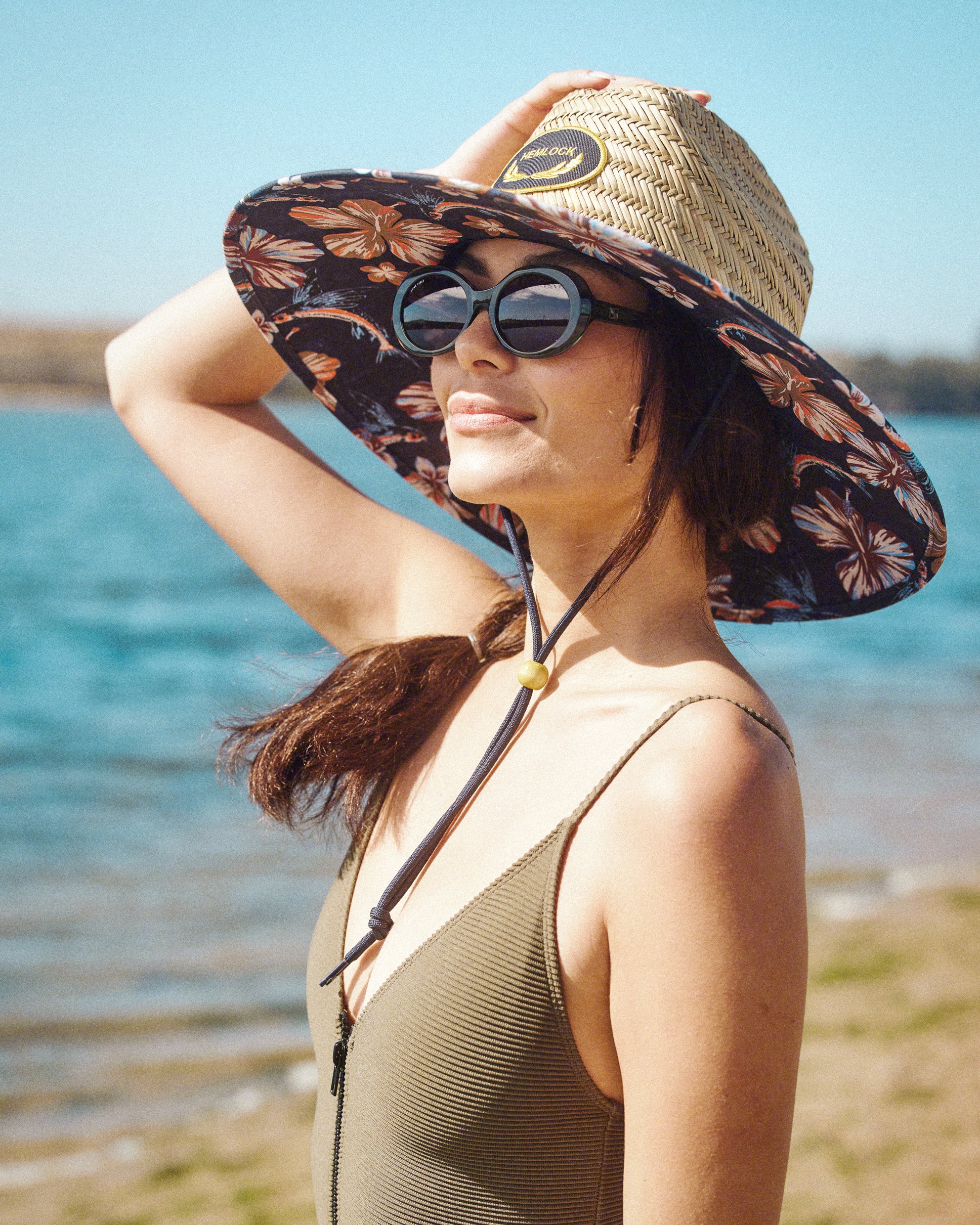 Hemlock female model wearing the UPF50+ Lifeguard Straw Hat Flying Fish print