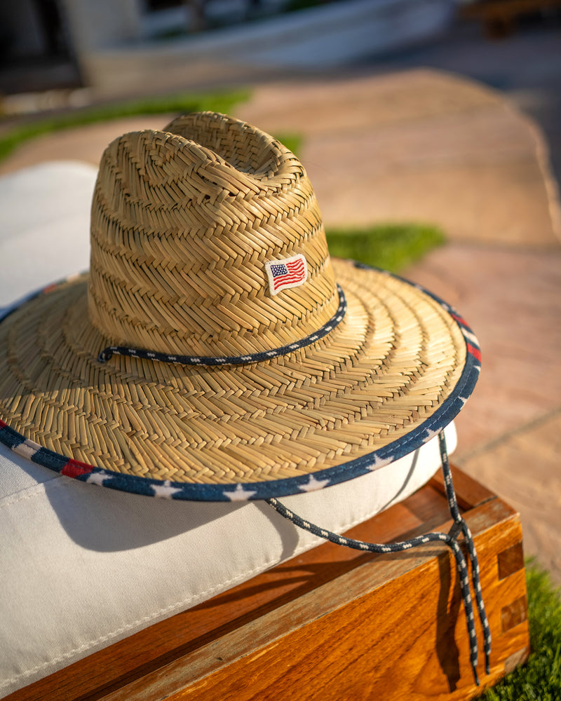 Hemlock Kids UPF50+ Lifeguard Straw Hat in Starts & Stripes print by pool chair