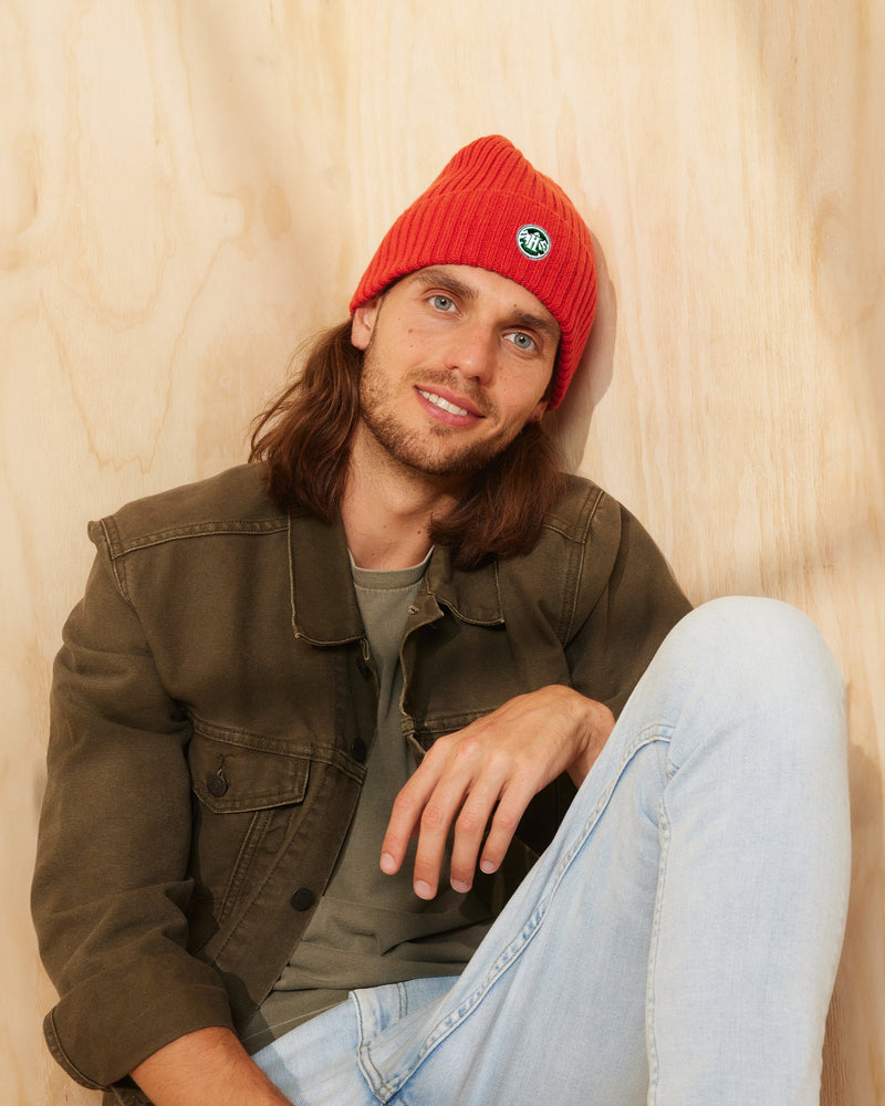 Hemlock male model wearing the Peak Beanie in Flame color