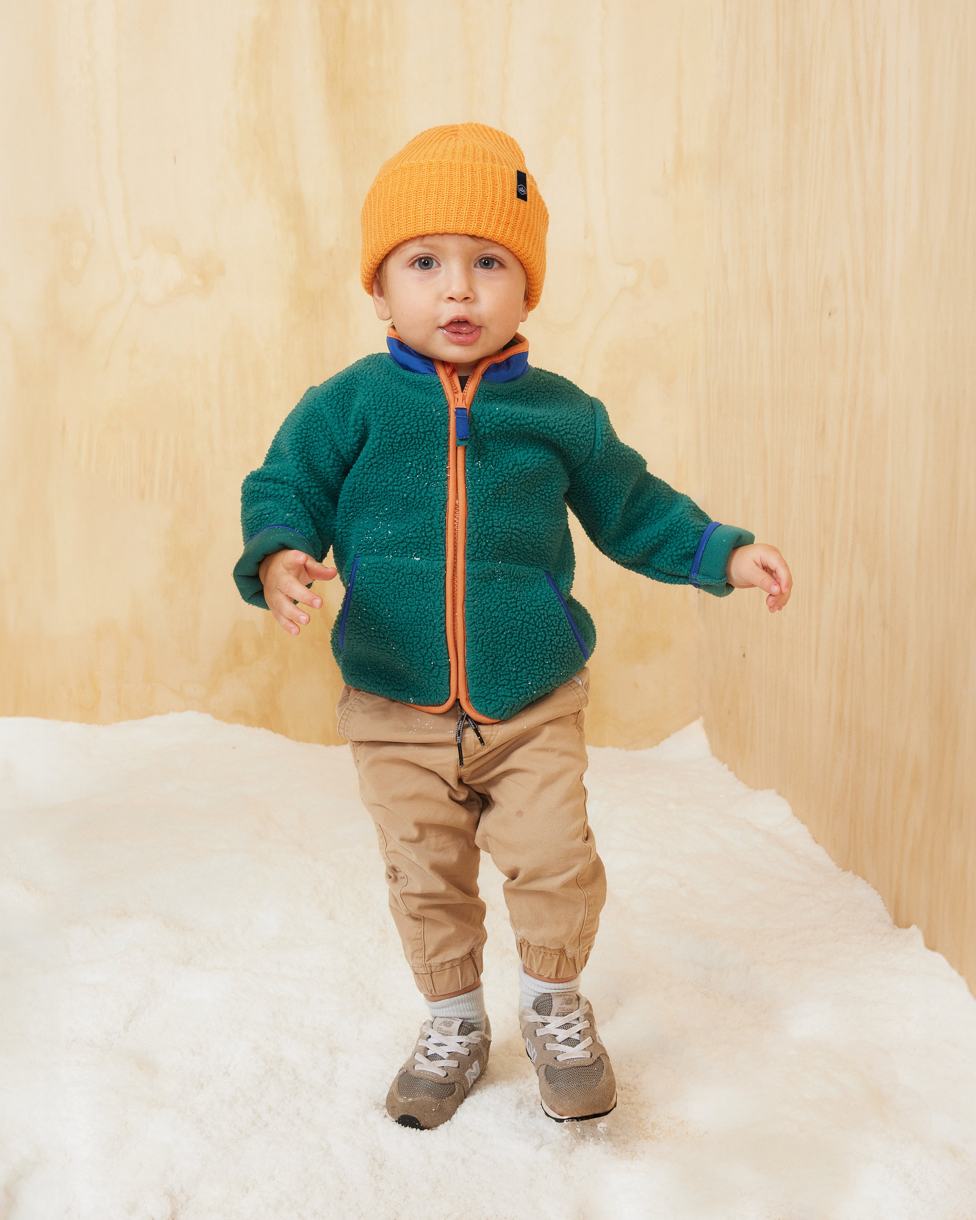 Hemlock baby boy model wearing the  Baby Ranger Beanie in Apricot color