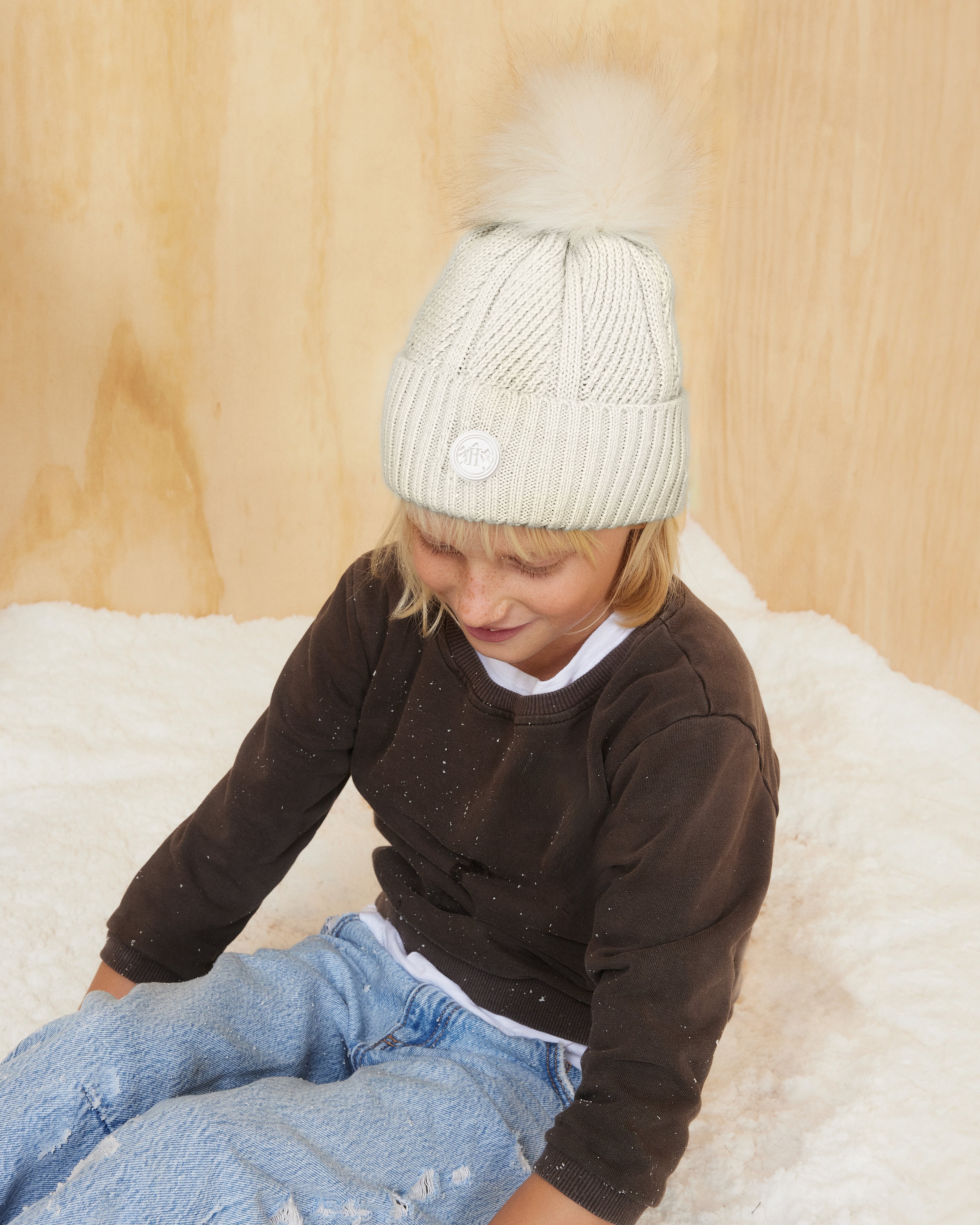 Hemlock little girl wearing the Toddler Willow Pom Beanie in Chalk color with white pom