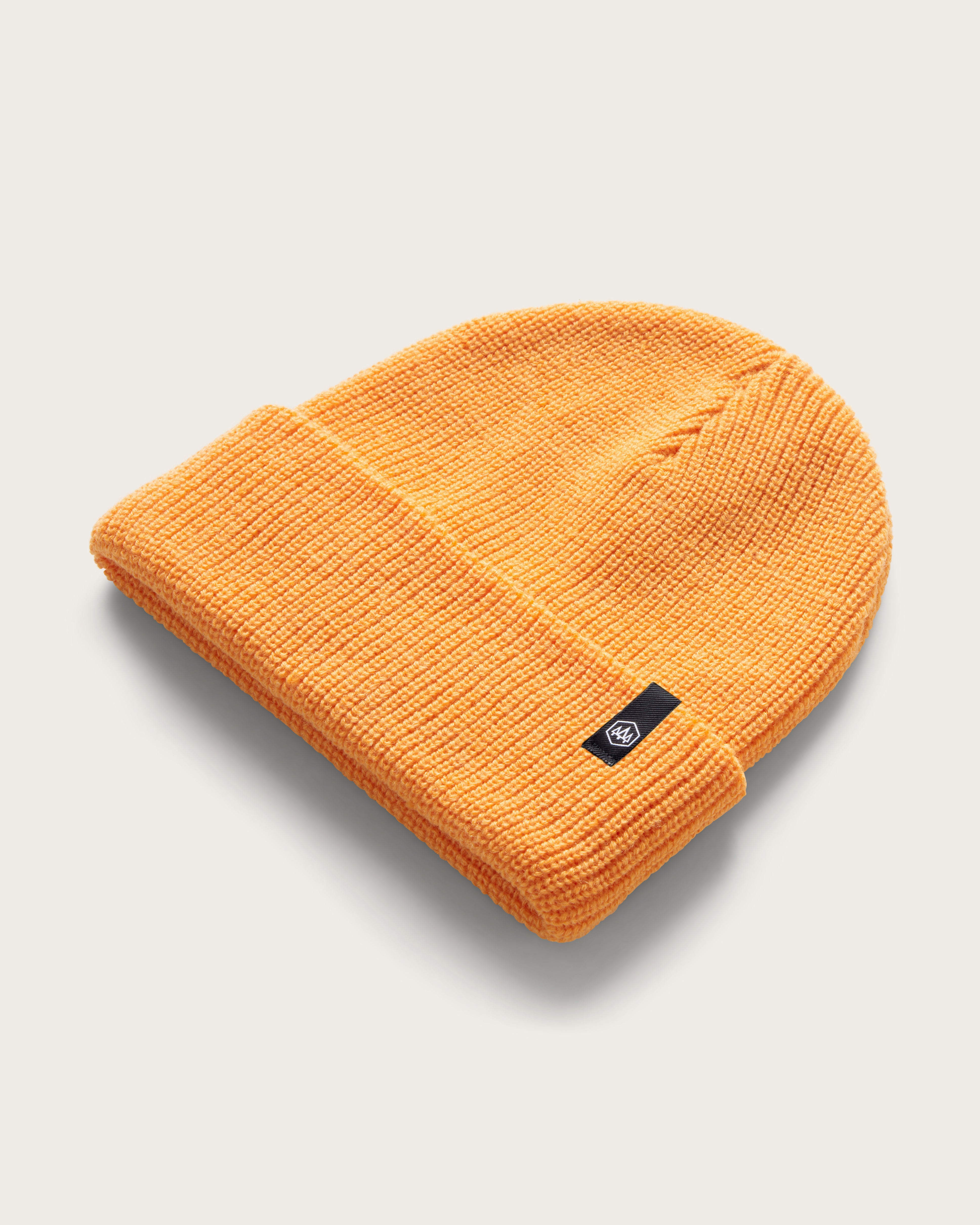 Hemlock Baby Ranger Beanie in Apricot color at an angle