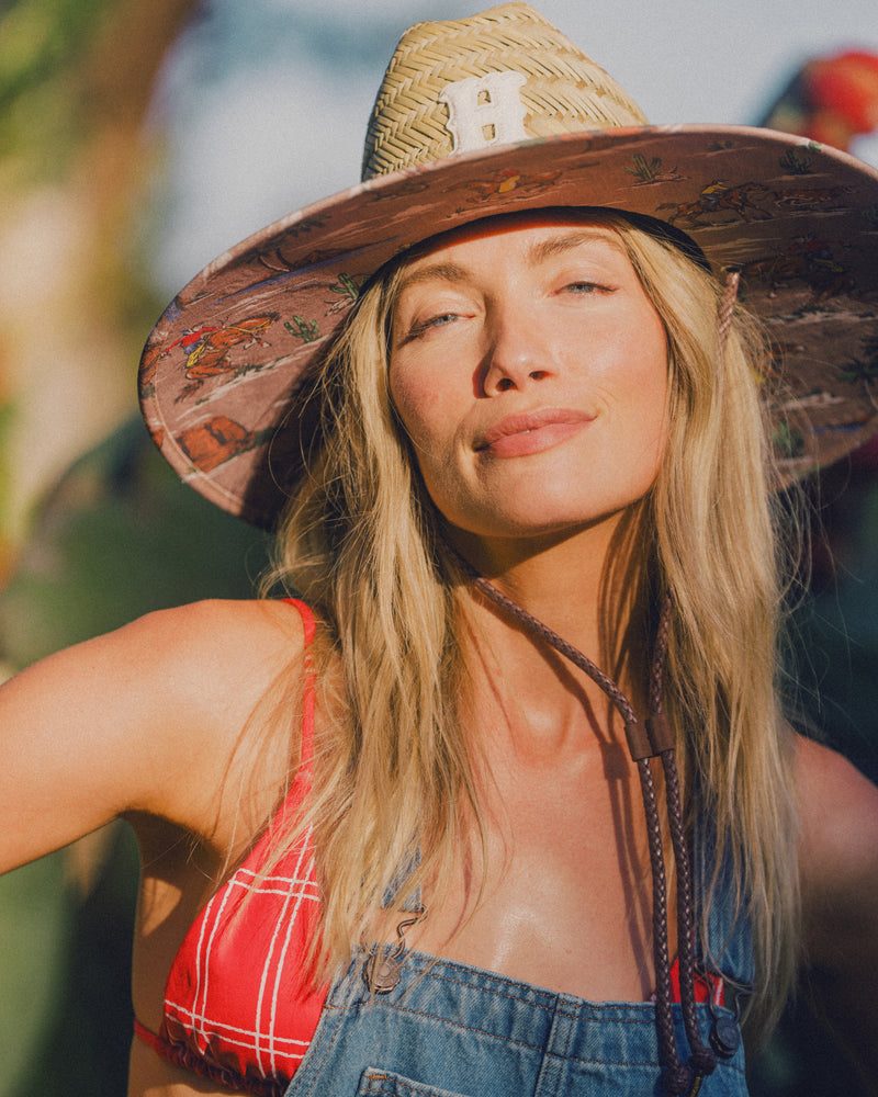 Hemlock female model wearing the UPF50+ Lifeguard Straw Hat Island Cowboy print close up