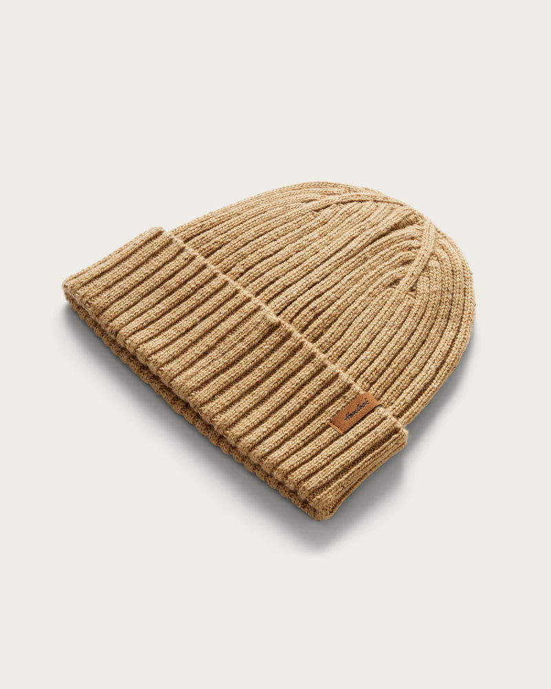 Hemlock Hawthorne Fleck Beanie in Sand Color at an angle 