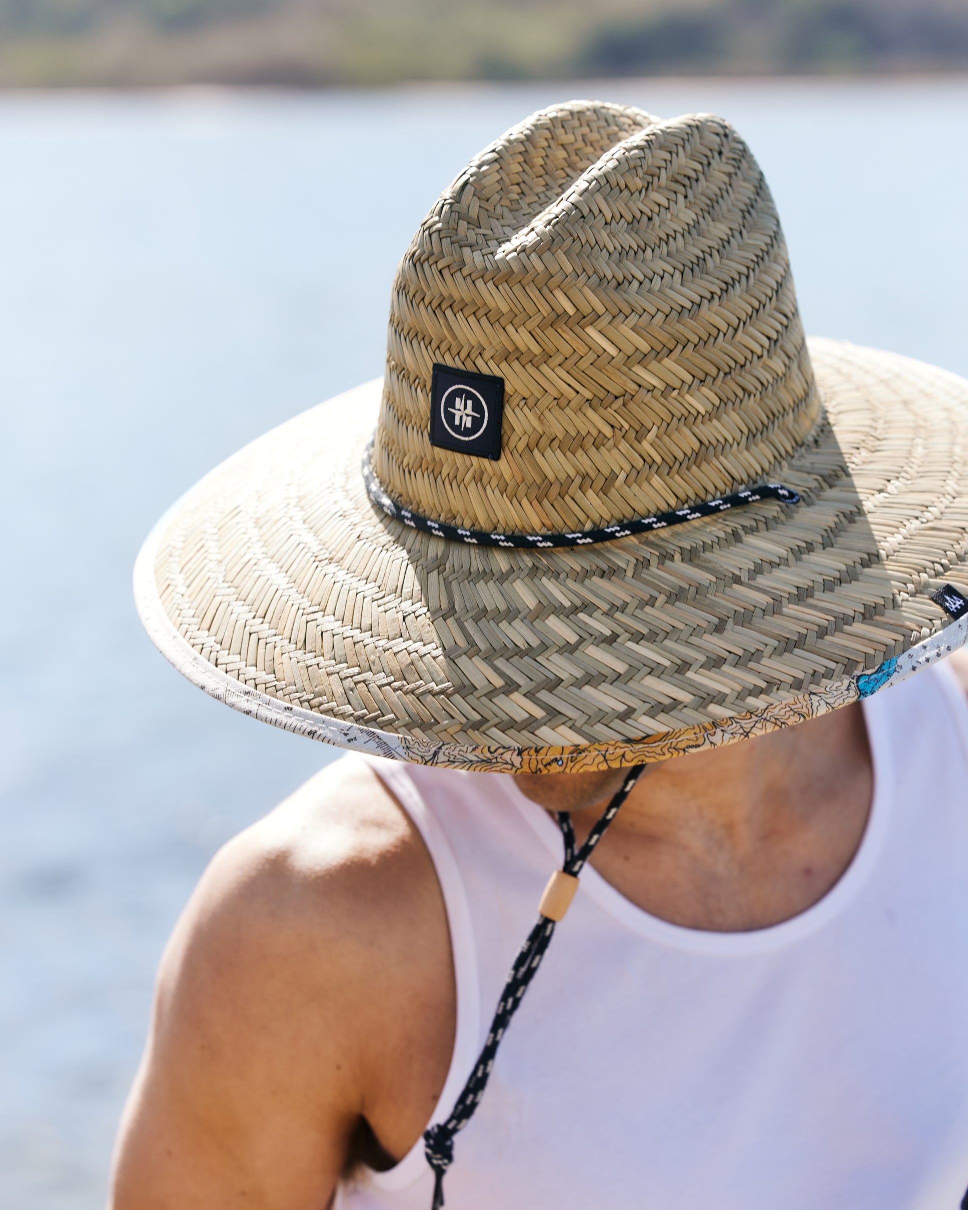 Hemlock male model wearing the UPF50+ Lifeguard Straw Hat Latitude print close up