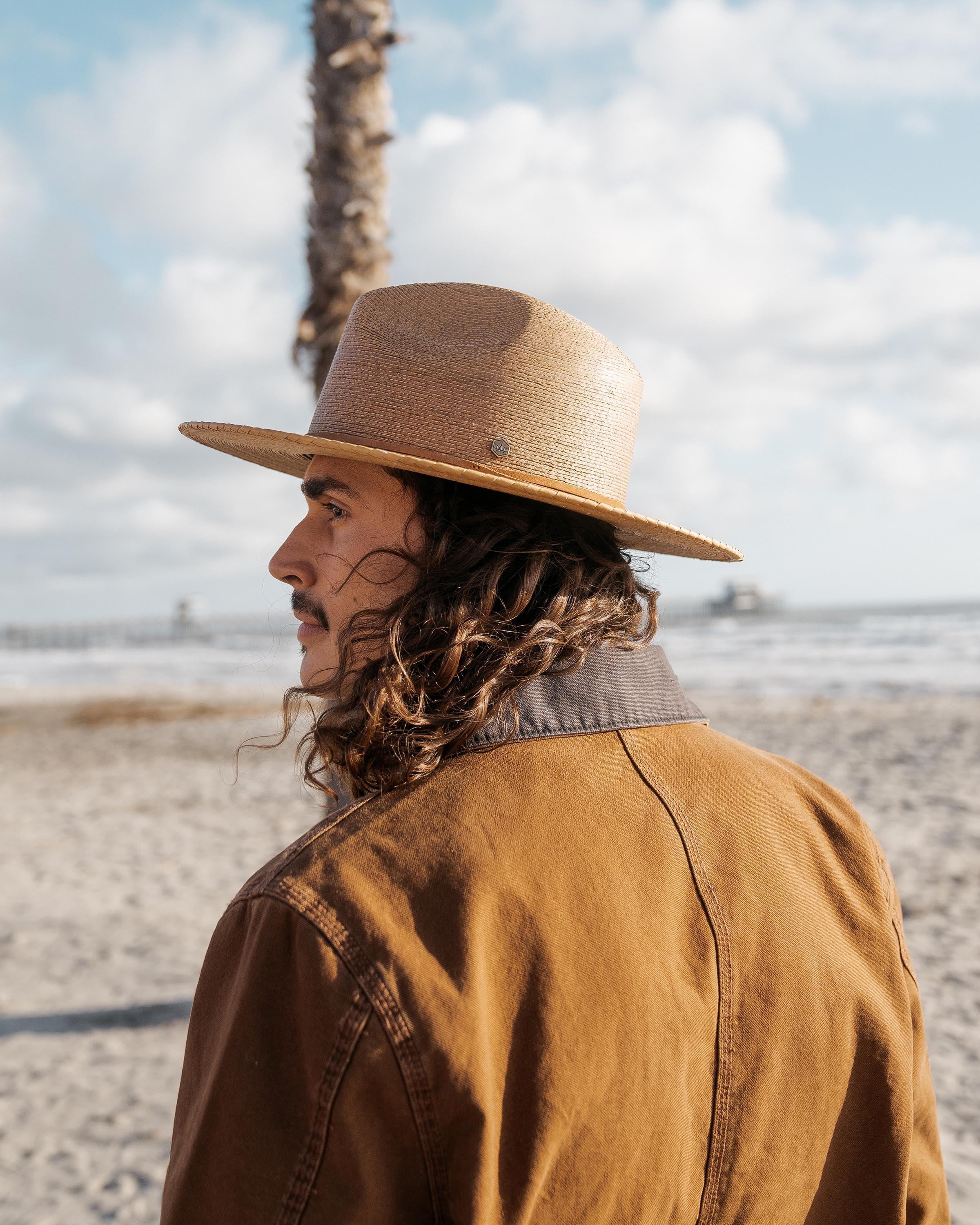 Hemlock male model side profile wearing Botero Straw Fedora in saddle