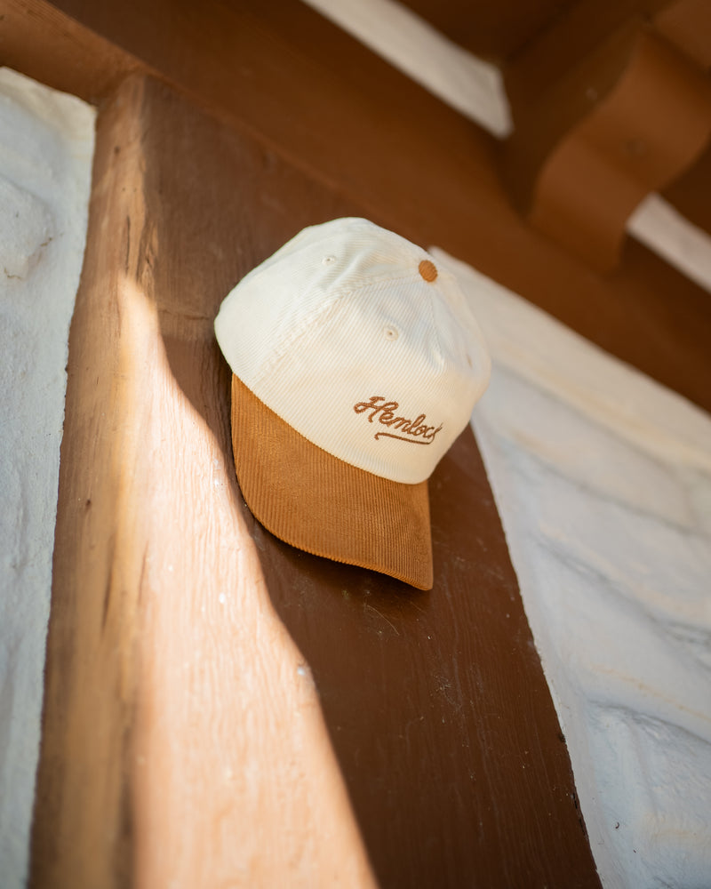 Hemlock Wesley Baseball Hat in Brown hanging on the wall