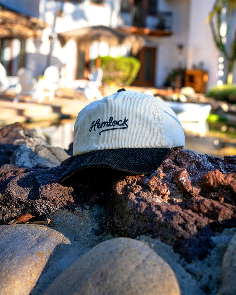 Hemlock Wesley Baseball Hat in Black by a pond