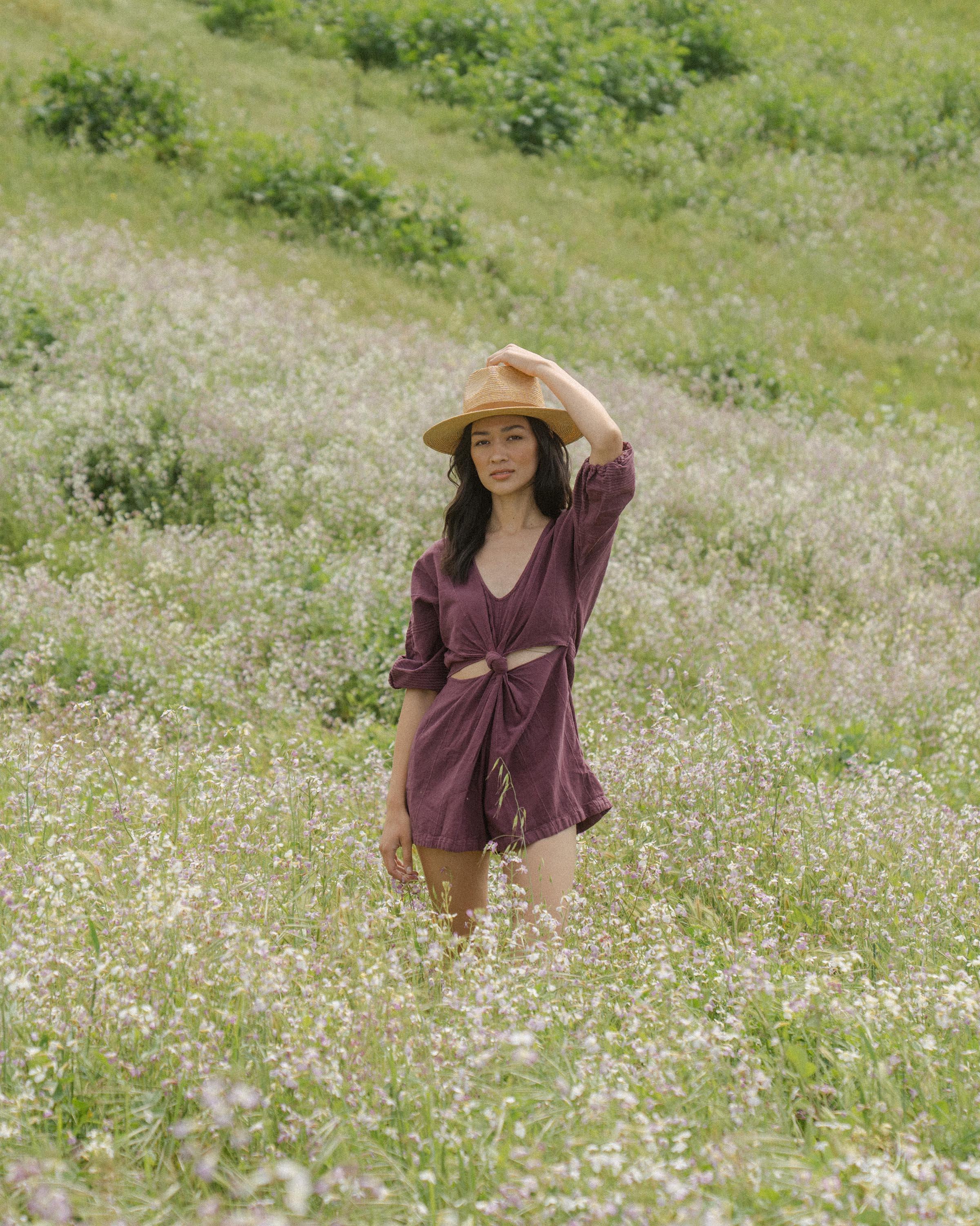 Hemlock female model looking straight wearing Logan Straw Fedora in Natural color