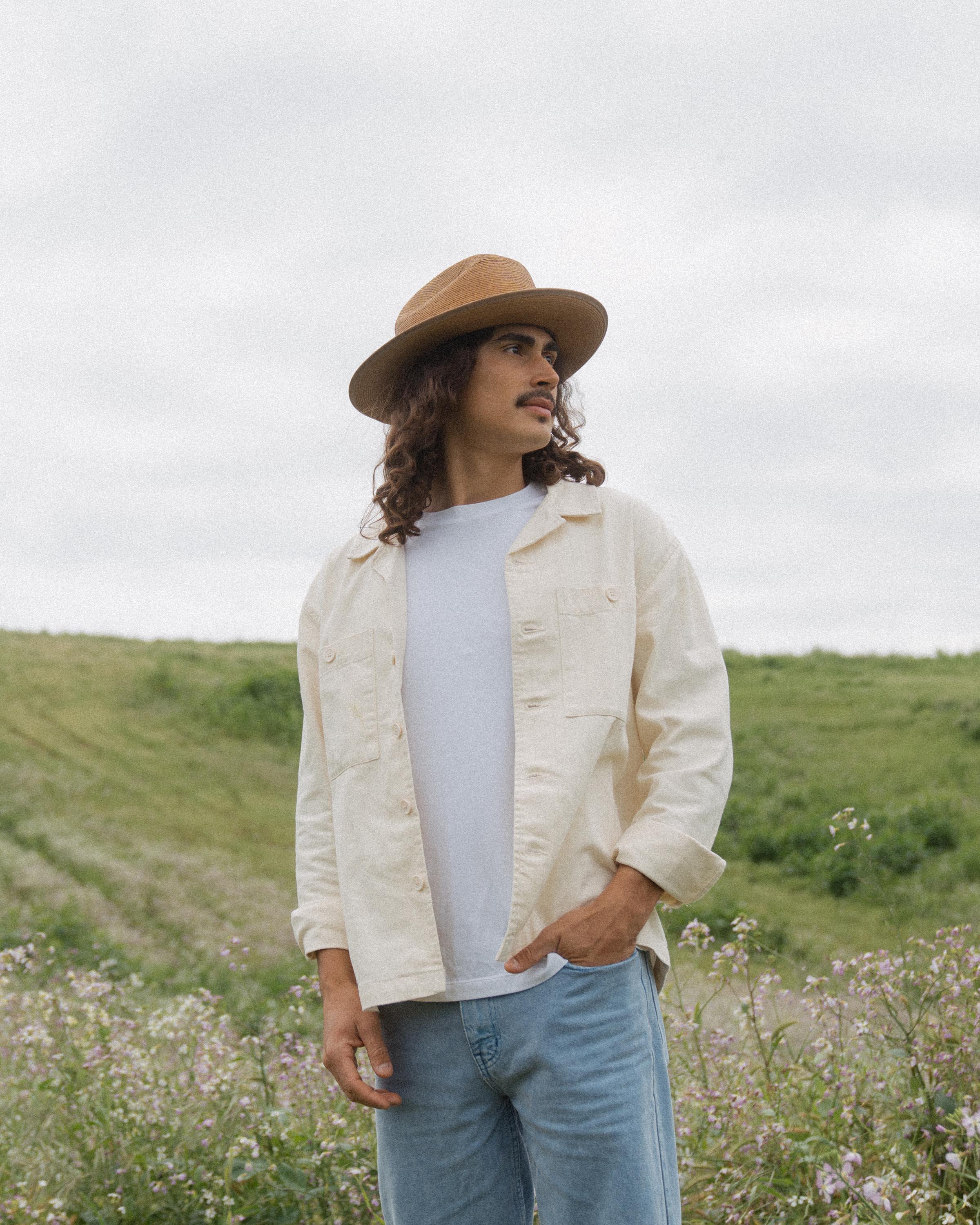 Hemlock male model looking right wearing Hemlock Mateo Straw Rancher Hat in Saddle