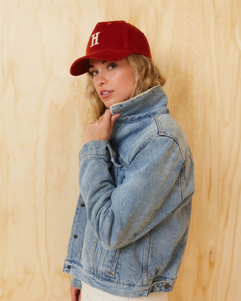 Hemlock female model wearing Rowan Trucker Hat in Rust color